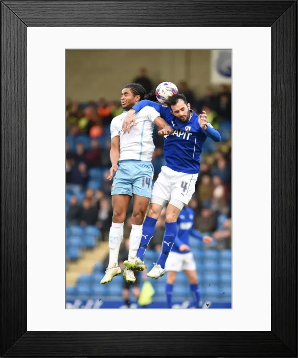 Framed Print : Battle for the Ball: Hird vs. Samuel in Sky Bet League One Clash at Proact Stadium Framed Print : Battle for the Ball: Hird vs. Samuel in Sky Bet League One Clash at Proact Stadium