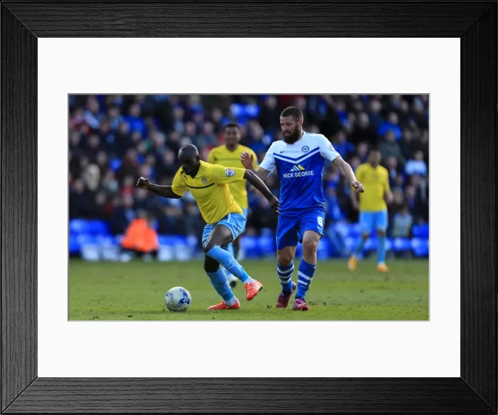 Framed Print : Intense Rivalry: Odelusi vs Bostwick's Battle for Ball Supremacy in Coventry City's Sky Bet League One Clash with Peterborough United