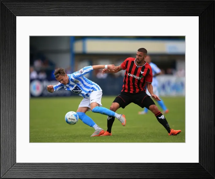 Framed Print : James Maddison Evasively Dodges Liam Secombe's Tackle in Coventry City's Pre-Season Friendly against Oxford United Framed Print : James Maddison Evasively Dodges Liam Secombe's Tackle in Coventry City's Pre-Season Friendly against Oxford United