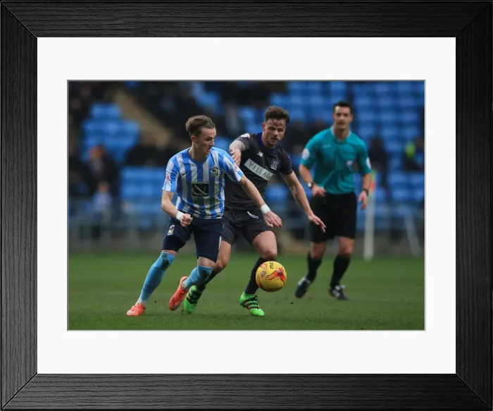 Framed Print : James Maddison Stands Firm Against Joe Riley in Intense Sky Bet League One Rivalry at Ricoh Arena Framed Print : James Maddison Stands Firm Against Joe Riley in Intense Sky Bet League One Rivalry at Ricoh Arena