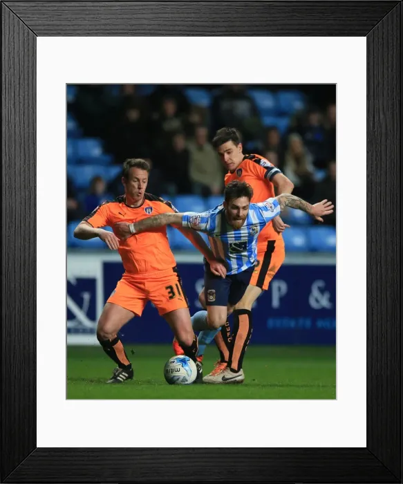 Framed Print : Intense Moment: Romain Vincelot of Coventry City Charges Forward Against Nicky Shorey and Owen Garvan of Colchester United at Ricoh Arena Framed Print : Intense Moment: Romain Vincelot of Coventry City Charges Forward Against Nicky Shorey and Owen Garvan of Colchester United at Ricoh Arena