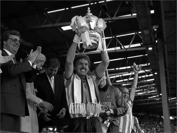 Coventry City captain Brian Kilcline lifts the FA Cup after his teams 3-2 victory