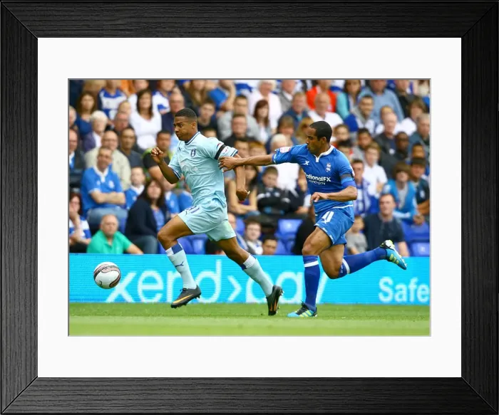 Framed Print : Cyrus Christie vs Jean Beausejour: Tense Moment in Birmingham City vs Coventry City Football Match