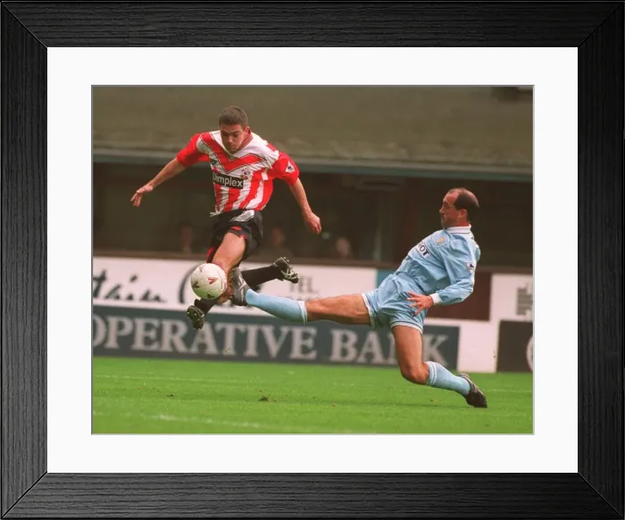 Framed Print : Jeff Kenna vs. David Rennie: A Battle of Football Giants Framed Print : Jeff Kenna vs. David Rennie: A Battle of Football Giants