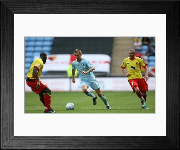 Framed Print : Carl Baker vs. Watford Defender: Intense Tackle in Coventry City's Npower Championship Match (August 20, 2011, Ricoh Arena) Framed Print : Carl Baker vs. Watford Defender: Intense Tackle in Coventry City's Npower Championship Match (August 20, 2011, Ricoh Arena)