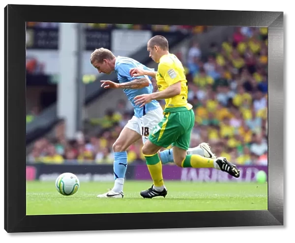 Carl Baker vs. Andrew Crofts: Intense Battle for Ball Possession in Coventry City vs. Norwich City Championship Clash (07-05-2011)