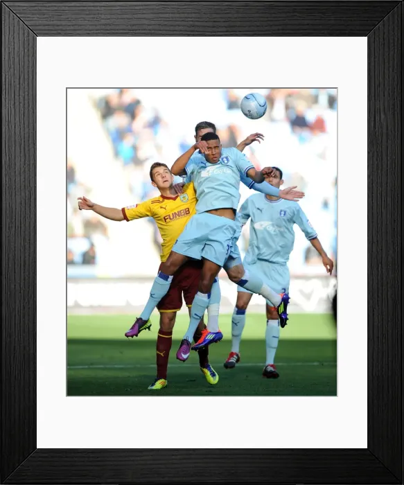 Framed Print : Coventry City vs Burnley: Cyrus Christie Wins a Header in Npower Championship Match at Ricoh Arena (2011)