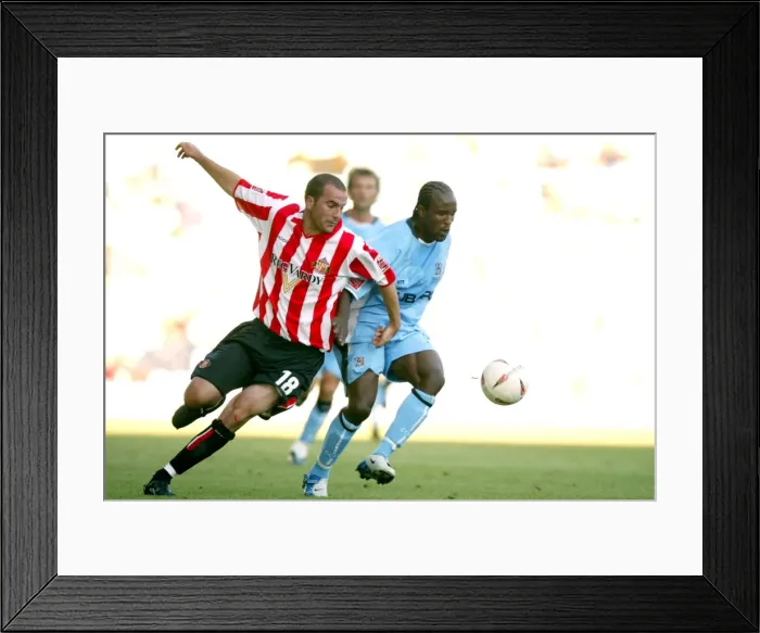 Framed Print : Clash at Highfield Road: A Battle Between Coventry City's Ben Clark and Sunderland's Patrick Suffo (07-08-2004) Framed Print : Clash at Highfield Road: A Battle Between Coventry City's Ben Clark and Sunderland's Patrick Suffo (07-08-2004)