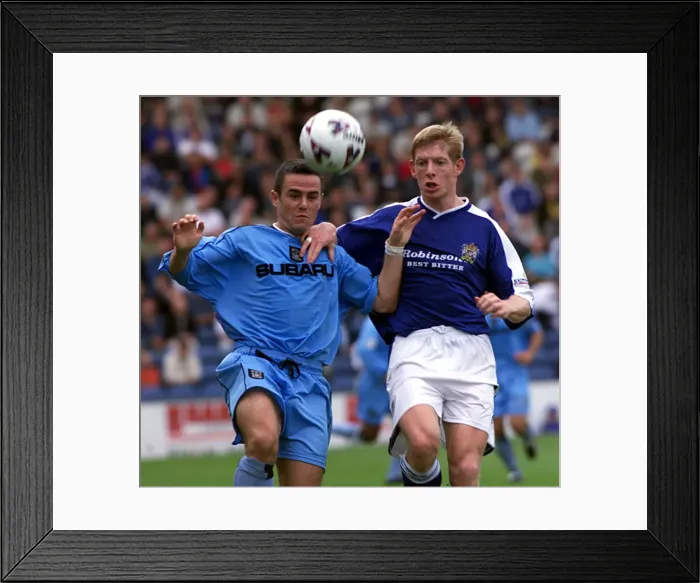 Framed Print : David Thompson of Coventry City Holds Off Stockport's Peter Clark in Intense Nationwide League Face-off