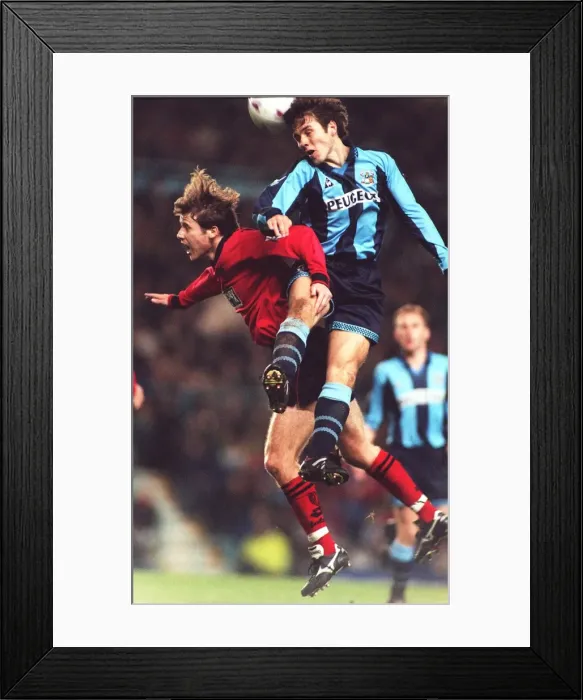 Framed Print : Thrilling Leap: Kenny Cunningham Soars Over Eion Jess in Coventry City vs Wimbledon Clash (Carling Premier League) Framed Print : Thrilling Leap: Kenny Cunningham Soars Over Eion Jess in Coventry City vs Wimbledon Clash (Carling Premier League)