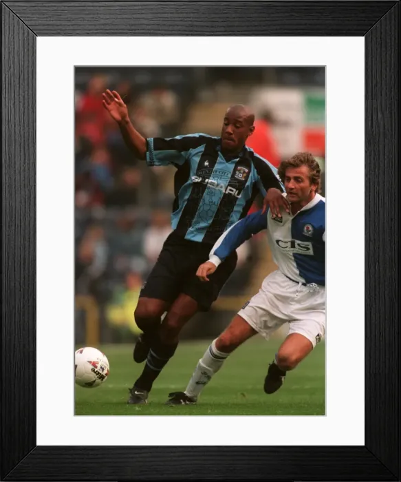 Framed Print : Dion Dublin's Determined Standoff Against Blackburn Rovers in FA Carling Premiership Clash Framed Print : Dion Dublin's Determined Standoff Against Blackburn Rovers in FA Carling Premiership Clash