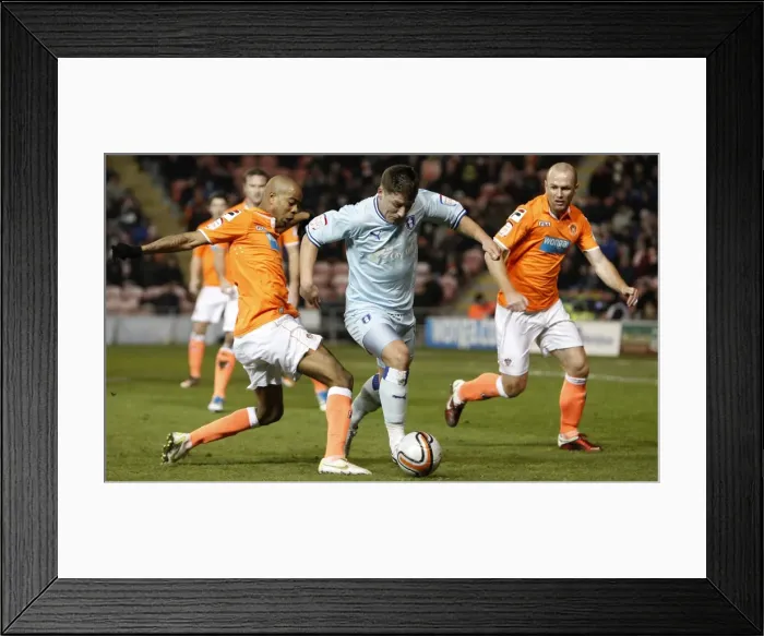 Framed Print : Gary Deegan Dodges Ludovic Sylvestre: Tight Chase in Coventry City vs Blackpool (31-01-2012) Framed Print : Gary Deegan Dodges Ludovic Sylvestre: Tight Chase in Coventry City vs Blackpool (31-01-2012)