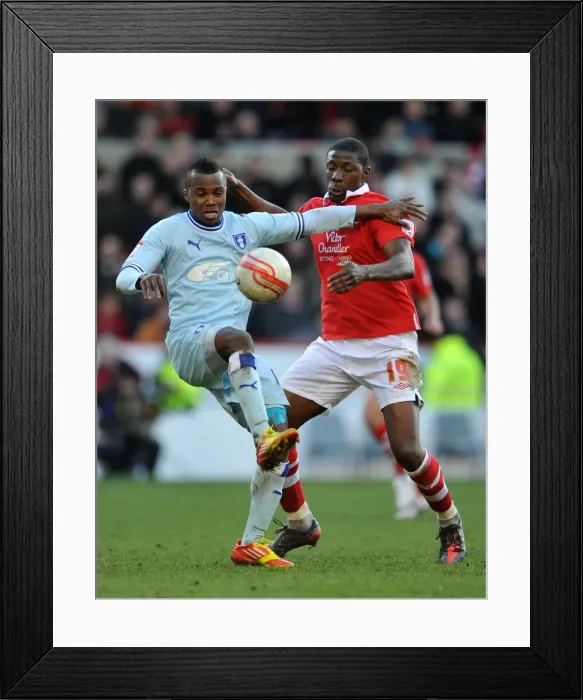 Framed Print : Moussi vs. Nimely: A Championship Showdown - Intense Rivalry between Coventry City's Alex Nimely and Nottingham Forest's Guy Moussi (18-02-2012, City Ground) Framed Print : Moussi vs. Nimely: A Championship Showdown - Intense Rivalry between Coventry City's Alex Nimely and Nottingham Forest's Guy Moussi (18-02-2012, City Ground)