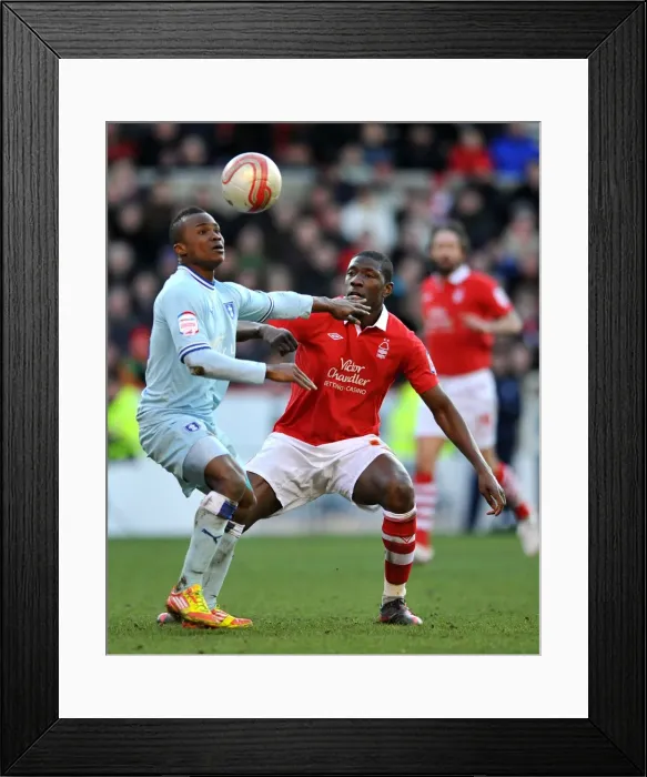 Framed Print : Intense Rivalry: Moussi vs. Nimely's Battle for Ball Supremacy in Coventry City's Championship Showdown at Nottingham Forest (18-02-2012) Framed Print : Intense Rivalry: Moussi vs. Nimely's Battle for Ball Supremacy in Coventry City's Championship Showdown at Nottingham Forest (18-02-2012)
