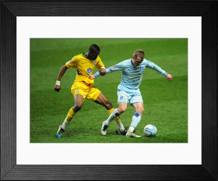 Framed Print : Wilfried Zaha vs. Gary McSheffrey: Npower Championship Showdown - A Clash at Ricoh Arena (06-03-2012)