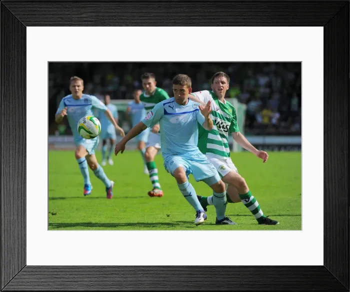 Framed Print : Cody McDonald's Determined Strike: Coventry City's Triumph over Yeovil's Richard Hinds (August 18, 2012) Framed Print : Cody McDonald's Determined Strike: Coventry City's Triumph over Yeovil's Richard Hinds (August 18, 2012)