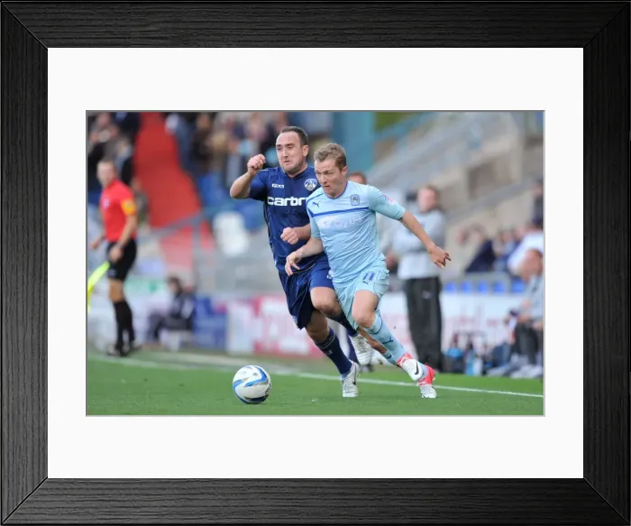 Framed Print : Battle for the Ball: Lee Croft vs. Gary McSheffrey - Npower League One Clash at Oldham Athletic's Boundary Park