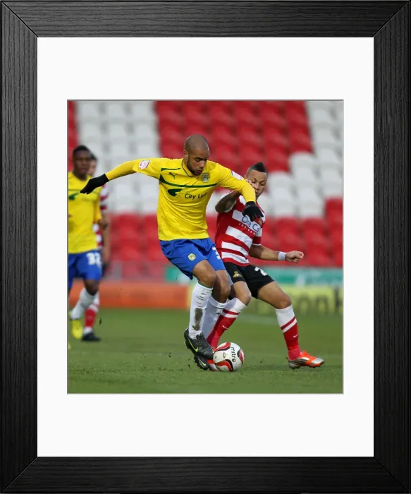 Framed Print : Intense Tackle: David McGoldrick vs Kyle Bennett in Npower League One Clash (Keepmoat Stadium, 15-12-2012) Framed Print : Intense Tackle: David McGoldrick vs Kyle Bennett in Npower League One Clash (Keepmoat Stadium, 15-12-2012)