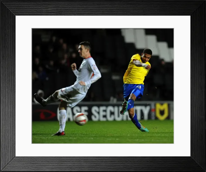 Framed Print : Milton Keynes Dons Shaun Williams Dodges Cyrus Christie's Shot in Npower League One Clash (December 29, 2012) Framed Print : Milton Keynes Dons Shaun Williams Dodges Cyrus Christie's Shot in Npower League One Clash (December 29, 2012)
