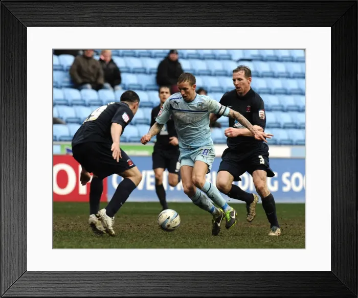 Framed Print : Clash at Ricoh Arena: Coventry City's Carl Baker Sandwiched Between Hartlepool's Defenders Framed Print : Clash at Ricoh Arena: Coventry City's Carl Baker Sandwiched Between Hartlepool's Defenders