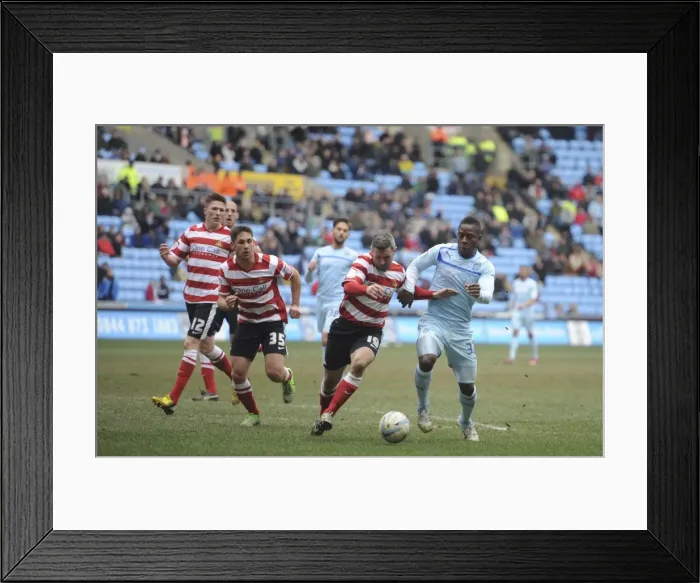 Framed Print : A Tense Clash: Coventry City's Franck Moussa vs Doncaster Rovers Andy Griffin in Npower League One at Ricoh Arena Framed Print : A Tense Clash: Coventry City's Franck Moussa vs Doncaster Rovers Andy Griffin in Npower League One at Ricoh Arena