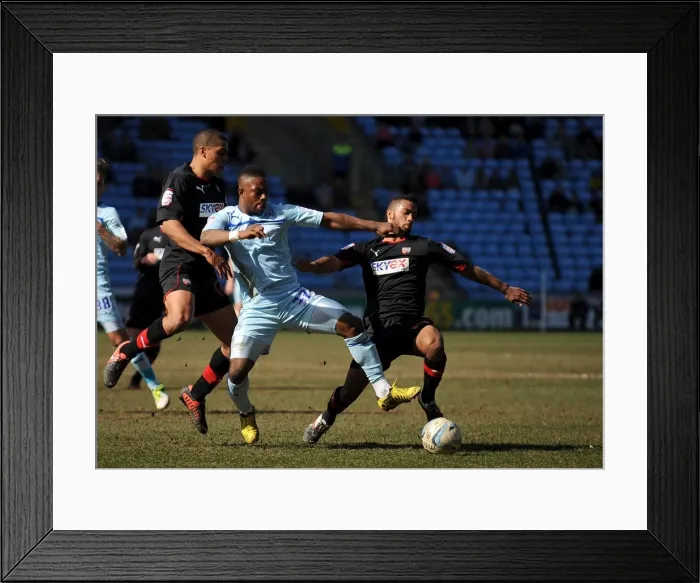 Framed Print : Battle for the Ball: Coventry City vs. Brentford in Football League One at Ricoh Arena