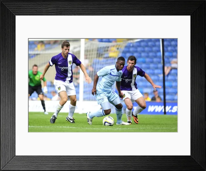 Framed Print : Friendly Rivalry: Jake Wright vs. Franck Moussa Clash at Kassam Stadium (Oxford United vs. Coventry City, 27-07-2013) Framed Print : Friendly Rivalry: Jake Wright vs. Franck Moussa Clash at Kassam Stadium (Oxford United vs. Coventry City, 27-07-2013)