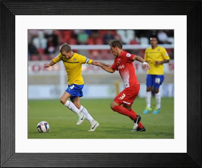 Framed Print : Carl Baker vs Gary Sawyer: Intense Rivalry in the Capital One Cup Clash between Leyton Orient and Coventry City
