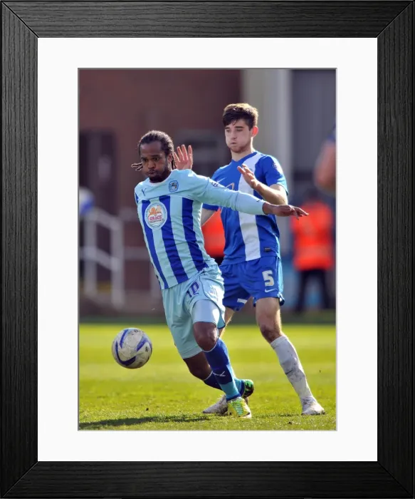 Framed Print : Intense Rivalry: A Clash Between Jack Baldwin and Nathan Delfouneso in the Sky Bet League One Match between Peterborough United and Coventry City Framed Print : Intense Rivalry: A Clash Between Jack Baldwin and Nathan Delfouneso in the Sky Bet League One Match between Peterborough United and Coventry City