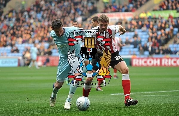 Battle for the Ball: Coventry City vs. Southampton - Coventry's Lukas Jutkiewicz vs. Southampton's Jos Hooiveld in Npower Championship Clash at Ricoh Arena