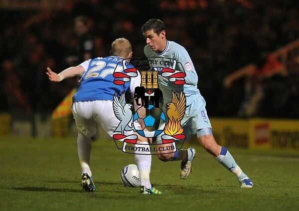 Battle for the Ball: Jutkiewicz vs Alcock in Coventry City's Championship Showdown with Peterborough United (December 17, 2011)