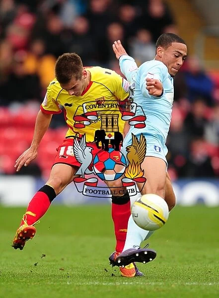 Battle for the Ball: Kacaniklic vs. Clarke in Coventry City's Npower Championship Clash at Vicarage Road