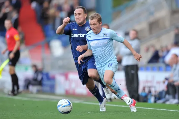 Framed Print : Battle for the Ball: Lee Croft vs. Gary McSheffrey - Npower League One Clash at Oldham Athletic's Boundary Park
