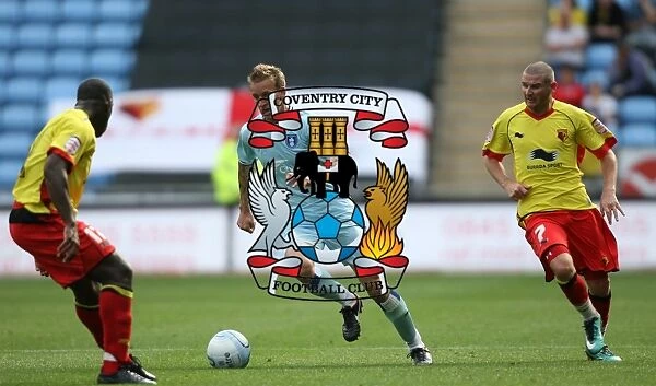 Carl Baker vs. Watford Defender: Intense Tackle in Coventry City's Npower Championship Match (August 20, 2011, Ricoh Arena)