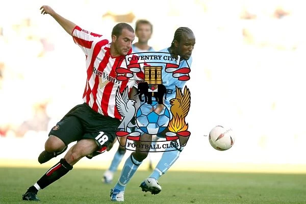 Clash at Highfield Road: A Battle Between Coventry City's Ben Clark and Sunderland's Patrick Suffo (07-08-2004)