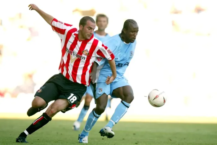 Framed Print : Clash at Highfield Road: A Battle Between Coventry City's Ben Clark and Sunderland's Patrick Suffo (07-08-2004) Framed Print : Clash at Highfield Road: A Battle Between Coventry City's Ben Clark and Sunderland's Patrick Suffo (07-08-2004)