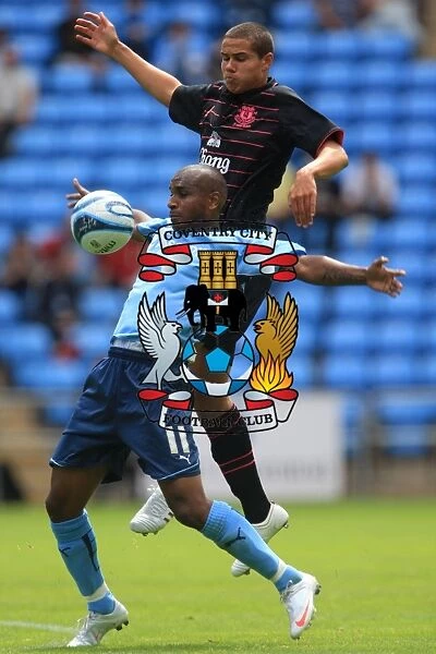 Clinton Morrison vs. Jack Rodwell: Intense Battle for the Ball in Coventry City's Pre-Season Friendly against Everton (August 2, 2009, Ricoh Arena)