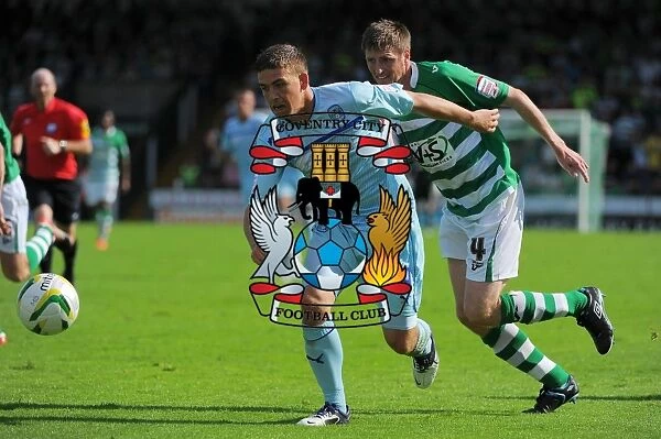 Cody McDonald's Determined Goal: Overcoming Richard Hinds in Coventry City's Victory at Huish Park (August 18, 2012)