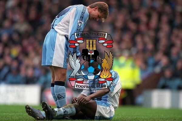 Comfort and Care: Roland Nilsson Consoles Injured George Boateng on the Field (FA Carling Premiership: Aston Villa vs Coventry City, 1999)