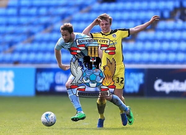 Coventry City sNick Proschwitz (left) and Colchester Uniteds Tom Lapslie battle for the ball