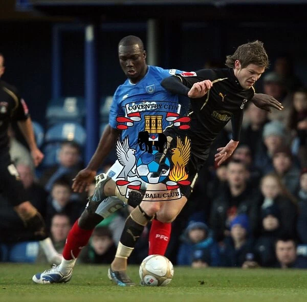 Coventry City's Aron Gunnarsson Evades Portsmouth's Papa Bouba Diop in FA Cup Third Round Clash at Fratton Park