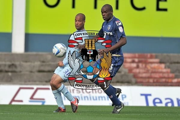 David McGoldrick vs. Jean Yves Mvoto Owono: A Fierce Battle for Possession in Coventry City's Npower League One Clash against Oldham Athletic (September 2012)