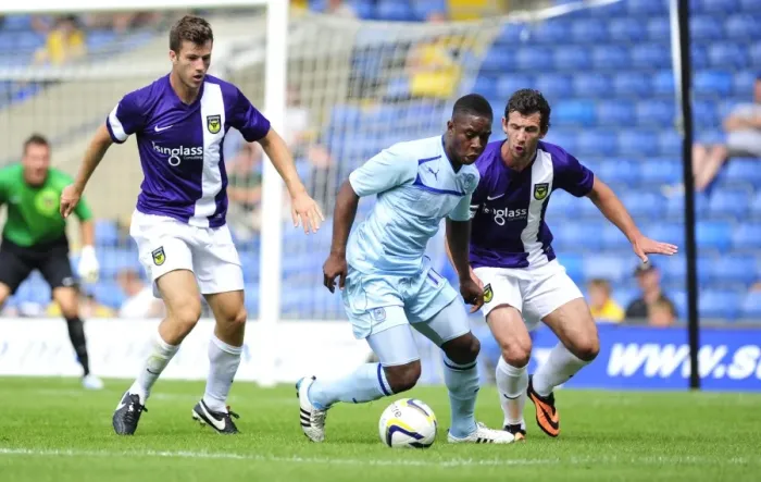 Framed Print : Friendly Rivalry: Jake Wright vs. Franck Moussa Clash at Kassam Stadium (Oxford United vs. Coventry City, 27-07-2013) Framed Print : Friendly Rivalry: Jake Wright vs. Franck Moussa Clash at Kassam Stadium (Oxford United vs. Coventry City, 27-07-2013)