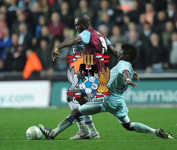 Gael Bigirimana vs. Carlton Cole: Intense Tackle in Coventry City vs. West Ham United Npower Championship Clash (19-11-2011)