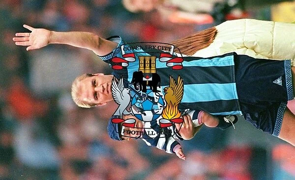 A Heartfelt Moment of Gratitude: David Busst and Son Cobi Thank Crowd at Coventry City's Benefit Match vs. Manchester United (1990s)