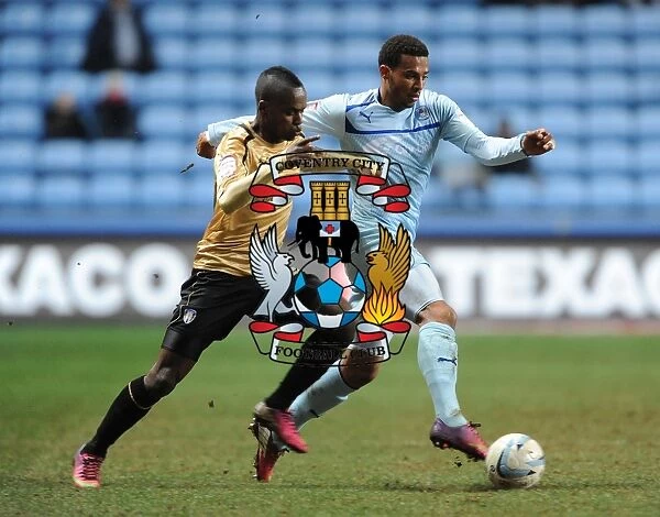 Intense Rivalry: Cyrus Christie vs. Gavin Massey's Battle for Ball Supremacy in Coventry City vs. Colchester United (Npower Football League One, Ricoh Arena, 12-3-2013)