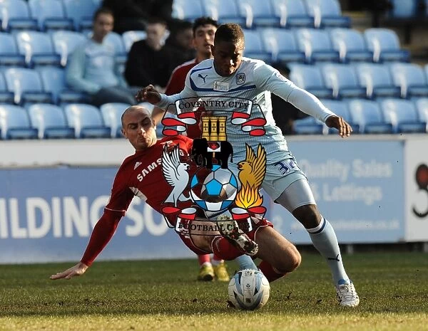 Intense Rivalry: Franck Moussa vs. Alan McCormack's Fierce Tackle in Coventry City vs. Swindon Town (Npower League One, 02-03-2013)
