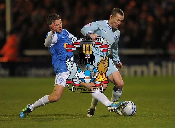 Intense Rivalry: McSheffrey vs. Kennedy's Battle for Ball Possession in Coventry City vs. Peterborough United (December 17, 2011, London Road)