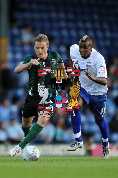 Intense Rivalry: McSheffrey vs. Mozika's Battle for Carling Cup Possession (Bury vs. Coventry City, 2011)