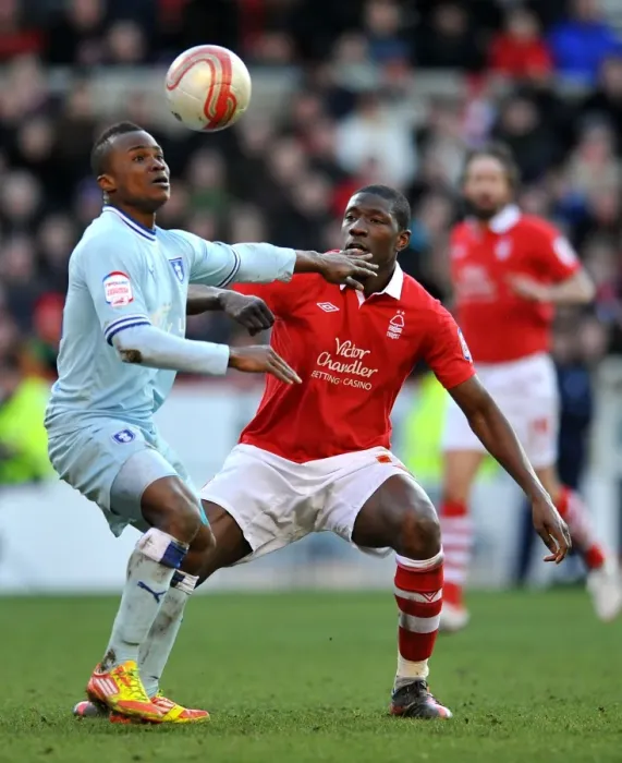 Framed Print : Intense Rivalry: Moussi vs. Nimely's Battle for Ball Supremacy in Coventry City's Championship Showdown at Nottingham Forest (18-02-2012) Framed Print : Intense Rivalry: Moussi vs. Nimely's Battle for Ball Supremacy in Coventry City's Championship Showdown at Nottingham Forest (18-02-2012)